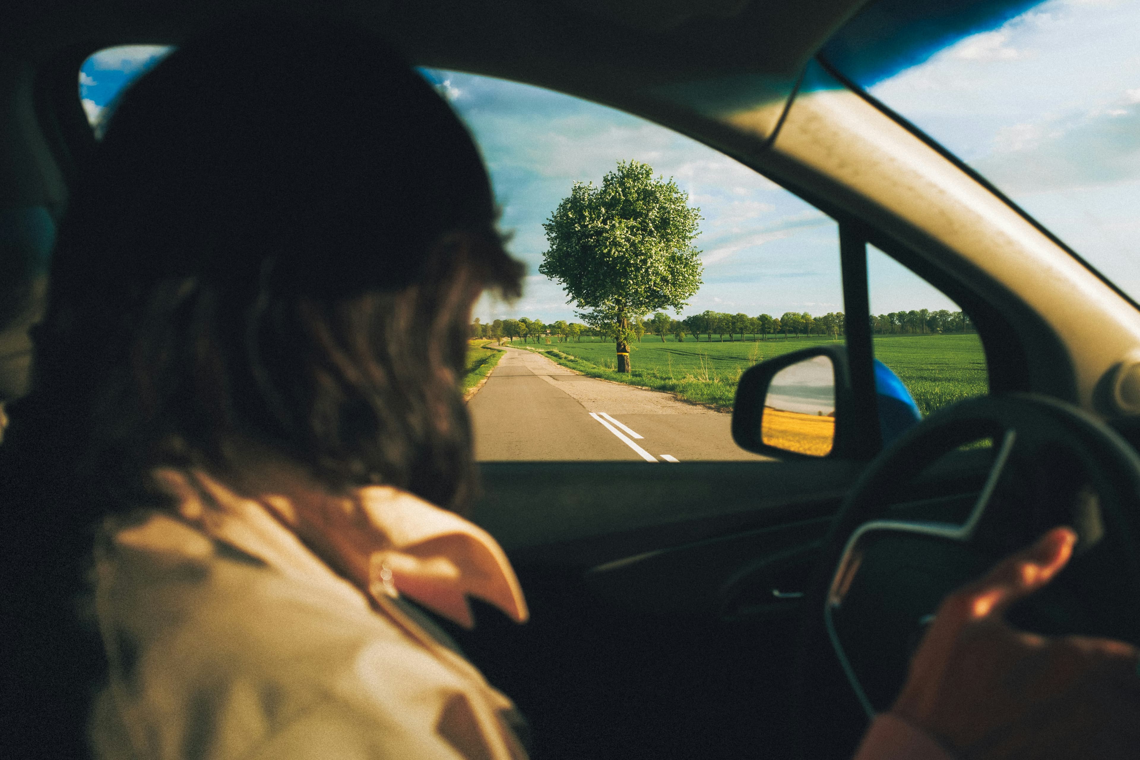 View from inside a car, the road ahead in late-afternoon light - moving forward, properly
